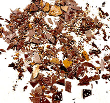 Load image into Gallery viewer, Black Sesame Seed Toffee Brittle Bits spread out on a piece of white paper
