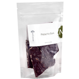 Closed clear bag of 3oz dark chocolate pistachio bark. Label states, “Pistachio Bark” with NeoCocoa logo.