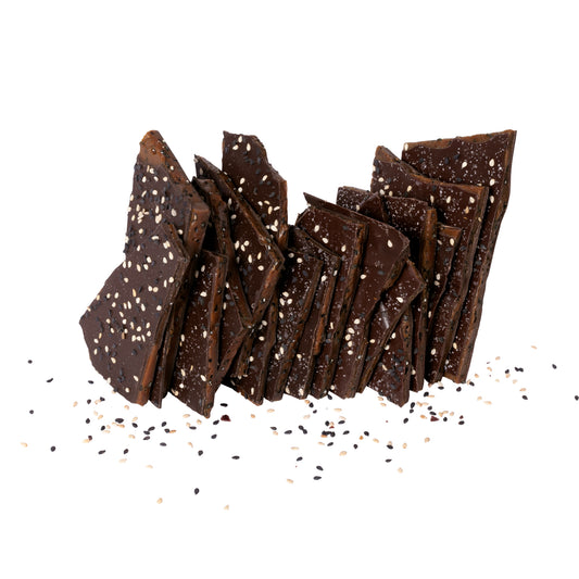 Close up of several pieces of sesame brittle candy stacked.