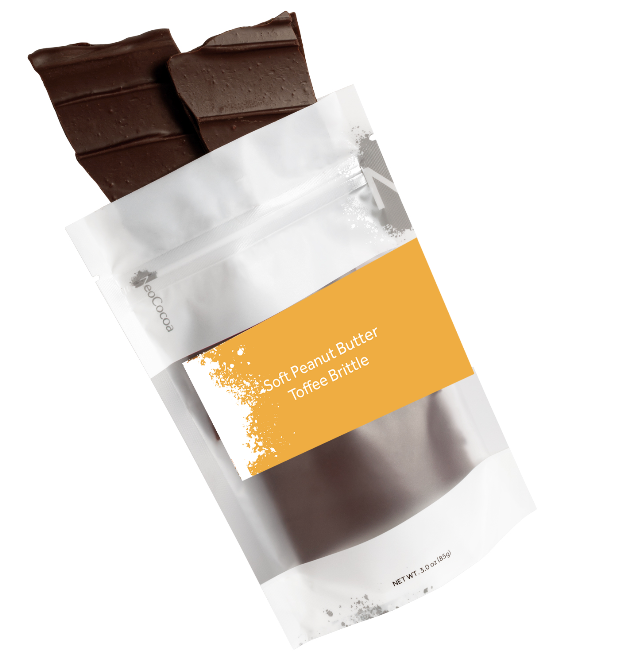 A stand-up pouch of chocolate brittle with a gold label reading 'Soft Peanut Butter Toffee Brittle' and pieces of dark chocolate brittle visible at the top, shown on a white background.