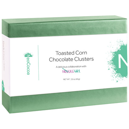 A rectangular box of NoCocoa Toasted Corn Chocolate Clusters, featuring a white label with green accents and text, set against a plain white background.