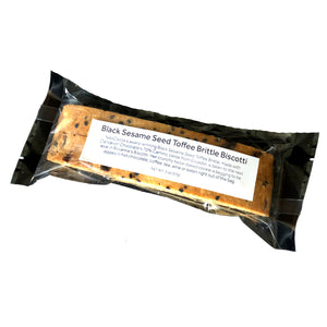 Clear bag with 2 pieces of sesame biscotti with a label stating "Black Sesame Seed Toffee Brittle Biscotti" 