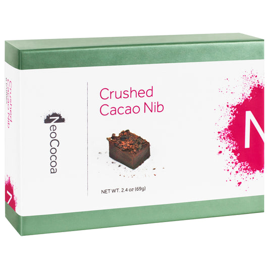 Closed 2 dimensional green rectangle box with a label wrapped around the center of the box stating, “Crushed Cacao Nib” with NeoCocoa logo and net weight 2.4 oz (69g). With a single image of a nib truffle with a little bit of cocoa powder sprinkles. 