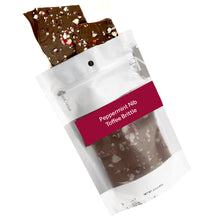 Load image into Gallery viewer, Peppermint nib brittle pouring out of 3oz sized bag with orange label stating “Peppermint Nib Toffee Brittle” and NeoCocoa logo.